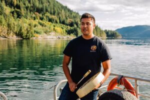 A Homalco tours team member playing a drum | Homalco Wildlife & Cultural Tours