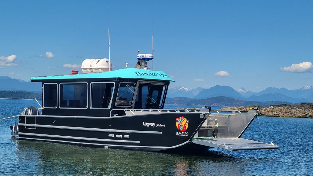 Homalco Tours boat waiting on the water | Homalco Wildlife & Cultural Tours